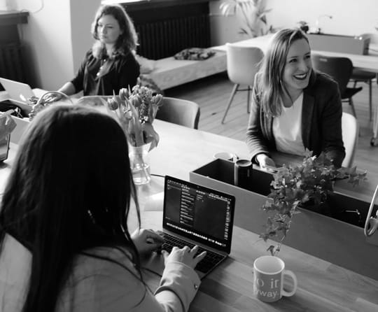 Team members working together at a desk in an office